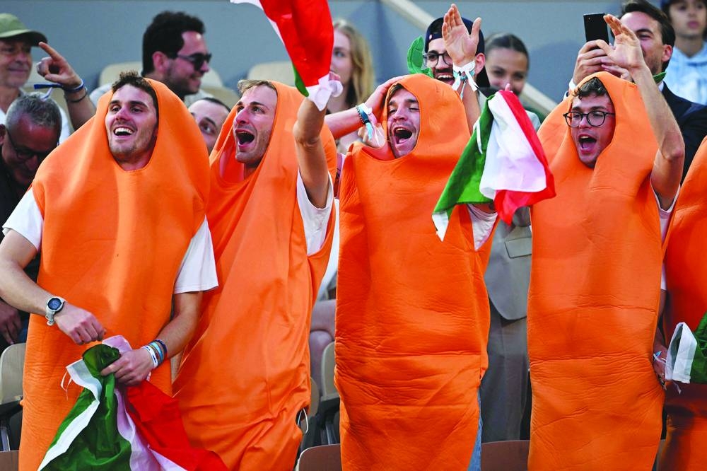 
Fans of Italy’s Jannik Sinner (below), dressed as carrots, gesture during his match against France’s Alexandre Muller on day two of the Roland-Garros Open at the Court Philippe-Chatrier in Paris on Monday. (AFP) 