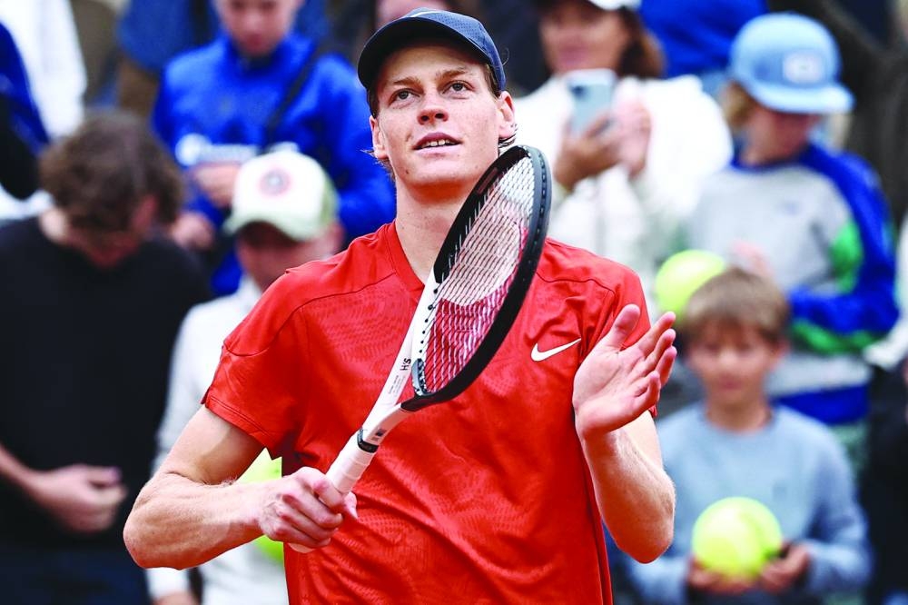 Italy's Jannik Sinner celebrates after winning his men's singles match against US Christopher Eubanks on Court Suzanne-Lenglen on day two of the French Open tennis tournament at the Roland Garros Complex in Paris on May 27, 2024. (Photo by Anne-Christine POUJOULAT / AFP)