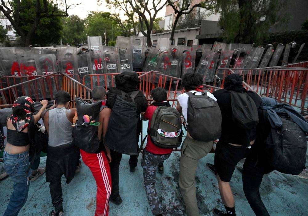  Demonstrators clash with police during a pro-Palestinian rally called "Urgent action for Rafah", held in front of the Israeli embassy in Mexico City on Tuesday. AFP