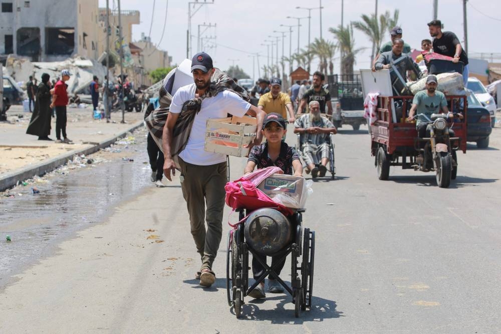 Palestinians flee with their belongings on foot or in vehicles as they leave Rafah in the southern Gaza Strip on Wednesday. AFP