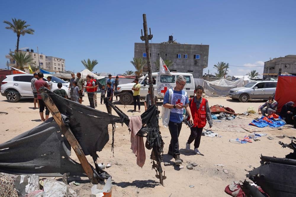 A delegation of the International Committee of the Red Cross (ICRC) inspects a makeshift displacement camp in Rafah's Mawasi area in the southern Gaza Strip on Wednesday, a site that was reportedly hit during Israeli bombardment. AFP