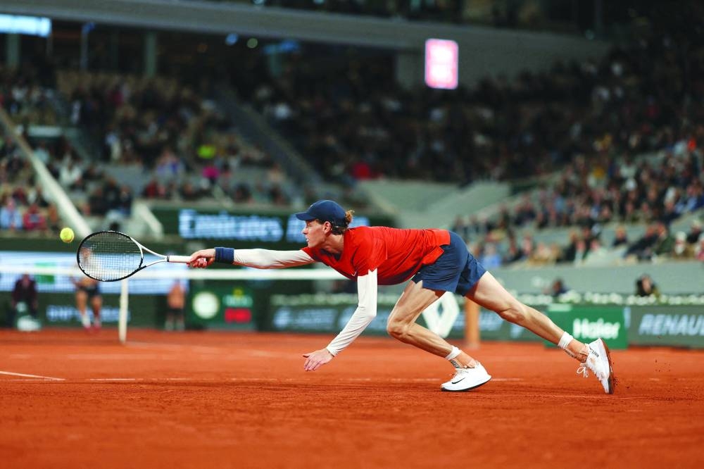 Italy’s Jannik Sinner plays a backhand return to Russia’s Pavel Kotov during the French Open second round match in Paris on Friday. (AFP)