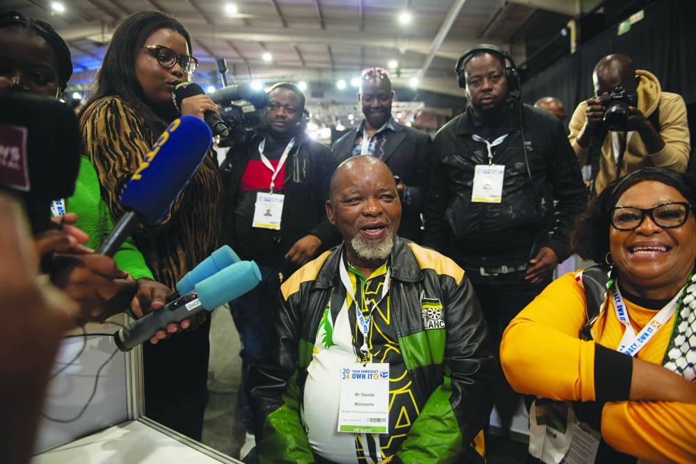 National Chairperson of the African National Congress Gwede Mantashe and Nomvula Paula Mokonyane, Deputy Secretary-General of the African National Congress sit at the ANC booth surrounded by media at the result board, at the National Results Operation Centre of the IEC, in Midrand, South Africa, on Saturday.