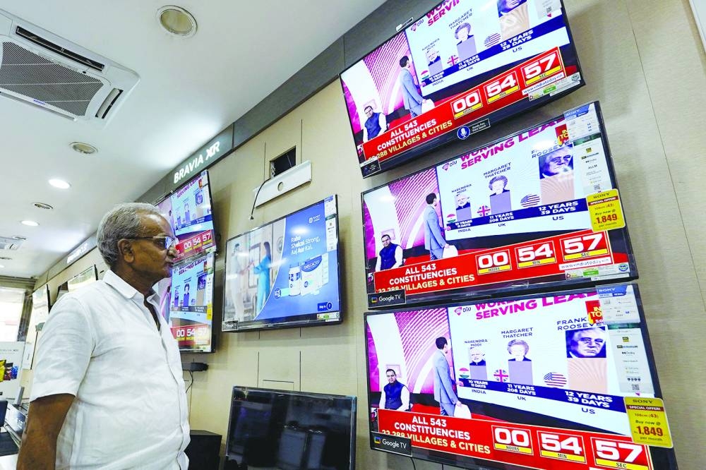 
A man watching television waits for the release of exit polls published after voting concludes during its seventh and final phase amid India’s general election, at an appliance store in Ajmer, India. 
