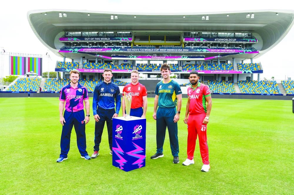 FROM LEFT: Richie Berrington of Scotland, Gerhard Erasmus of Namibia, Jos Buttler of England, Mitchell Marsh of Australia and Aqib Ilyas of Oman with the trophy on Saturday, ahead of the start of the ICC Men’s T20 CWC at Kensington Oval, Bridgetown, Barbados. (AFP)
