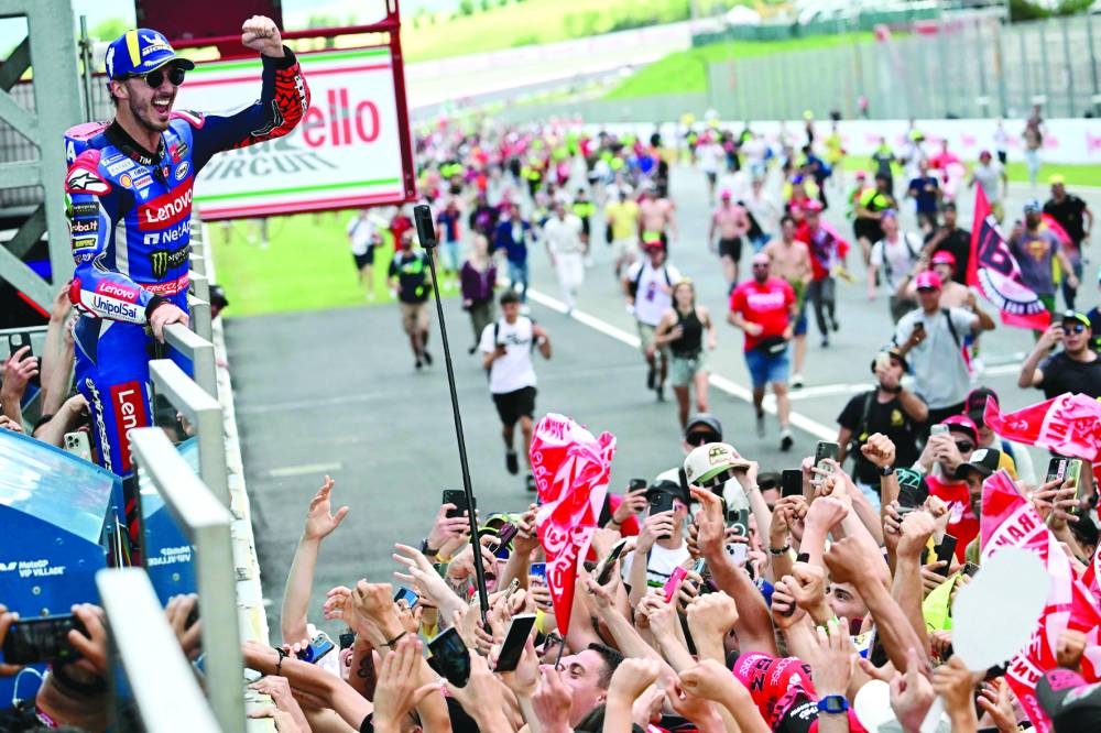 Ducati Italian rider Francesco Bagnaia celebrates with fans after winning the Italian Grand Prix at Mugello on Sunday. (AFP)