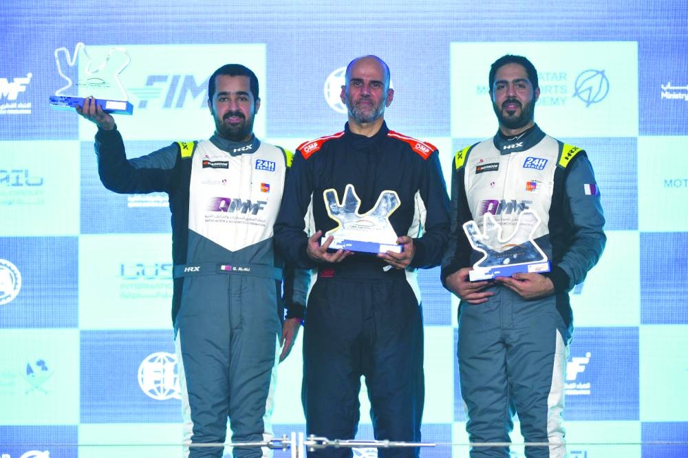 
Winner Mansour al-Hajri (centre), second-placed Ghanim al-Madheed (left) and third-placed Ahmed al-Asiri celebrate on the podium of QTCC Race 1 at Lusail International Circuit. 