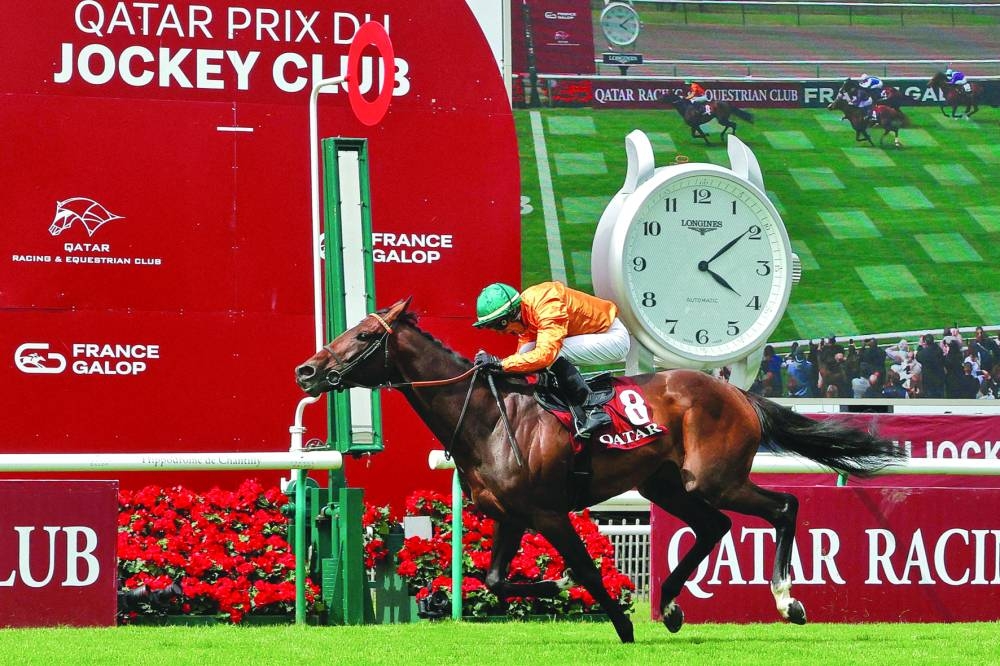 French jockey Ronan Thomas and his horse Look de Vega cross the finish line to win the 184th Qatar Prix du Jockey Club at the Chantilly Race Course in Paris on Sunday. (AFP)