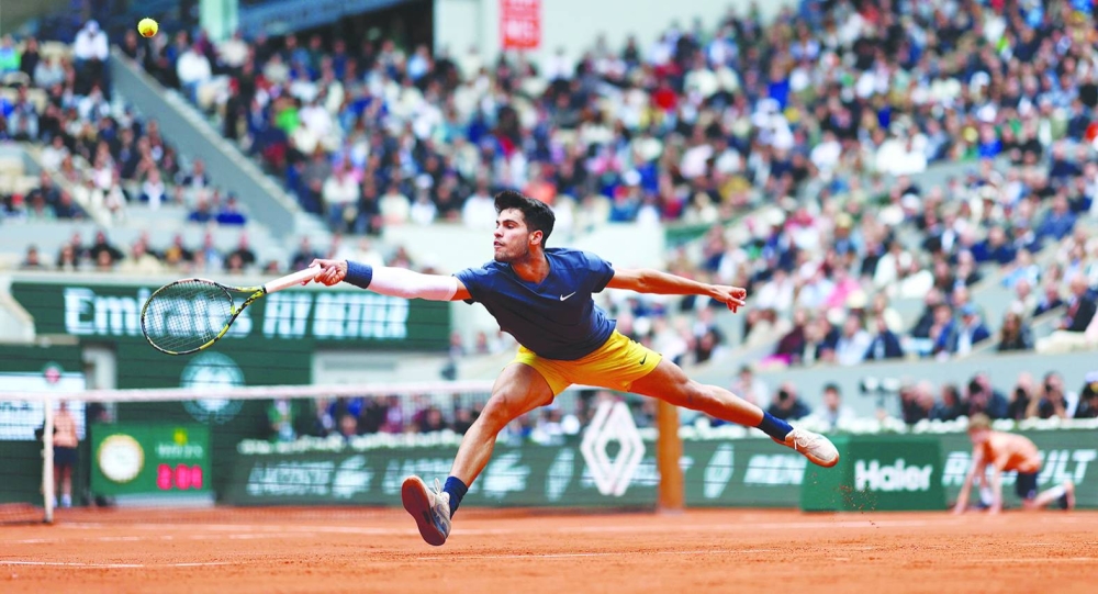 Spain’s Carlos Alcaraz Garfia plays a backhand return to Canada’s Felix Auger-Aliassime during their match on day eight of the French Open at the Roland Garros Complex in Paris on Sunday. (AFP)