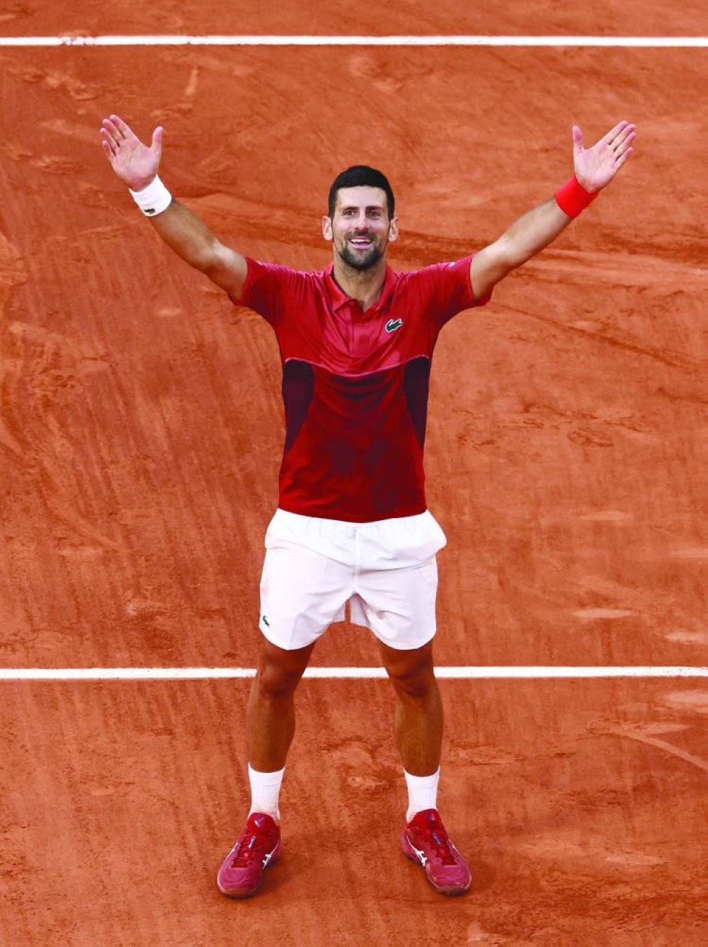 Serbia’s Novak Djokovic celebrates after winning his French Open fourth round match against Argentina’s Francisco Cerundolo at the Roland Garros Complex in Paris on Monday. (Reuters)