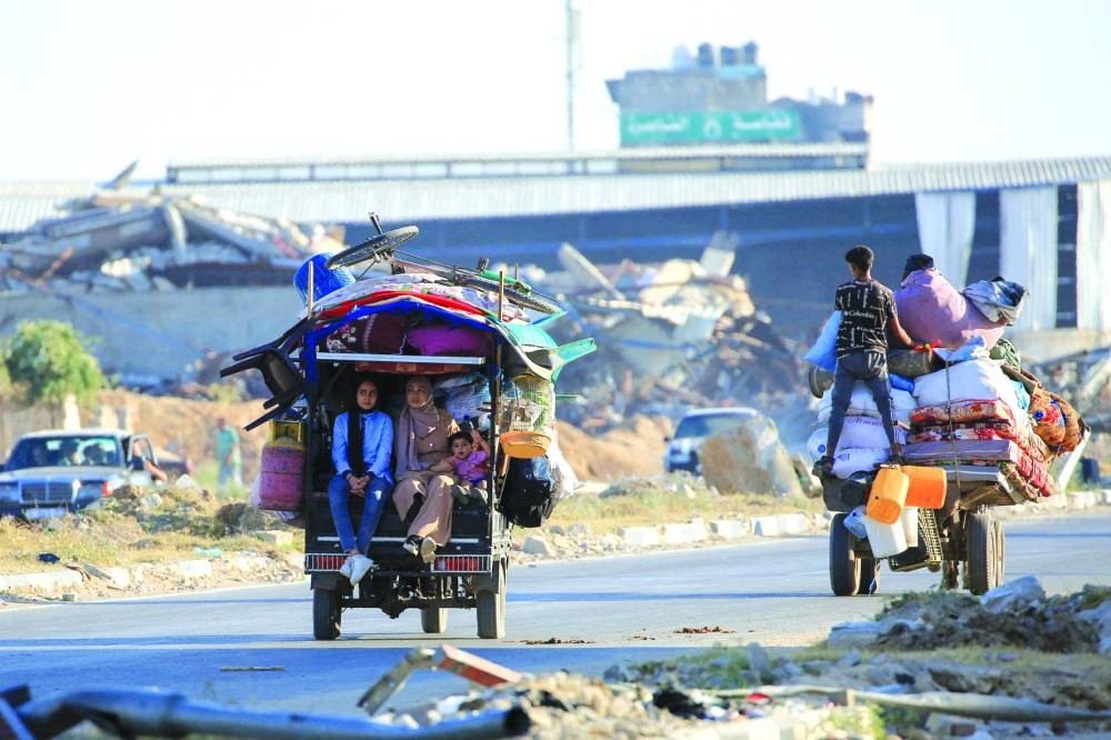 Palestinians take to the road in Al-Maghazi as they flee due to  heavy Israeli bombardment of the central Gaza Strip Wednesday.