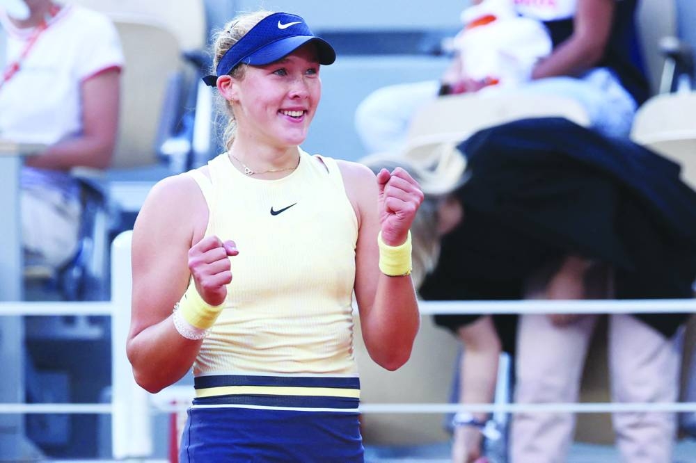 Russia’s Mirra Andreeva celebrates after winning against Belarus’ Aryna Sabalenka in the French Open quarter-final in Paris on Wednesday. (AFP)