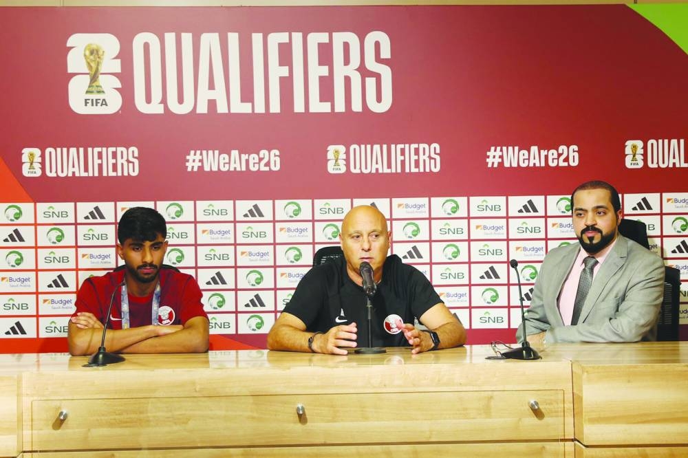 Qatar coach Marquez Lopez and midfielder Nayef al-Hadrami (left) address the media on Wednesday.