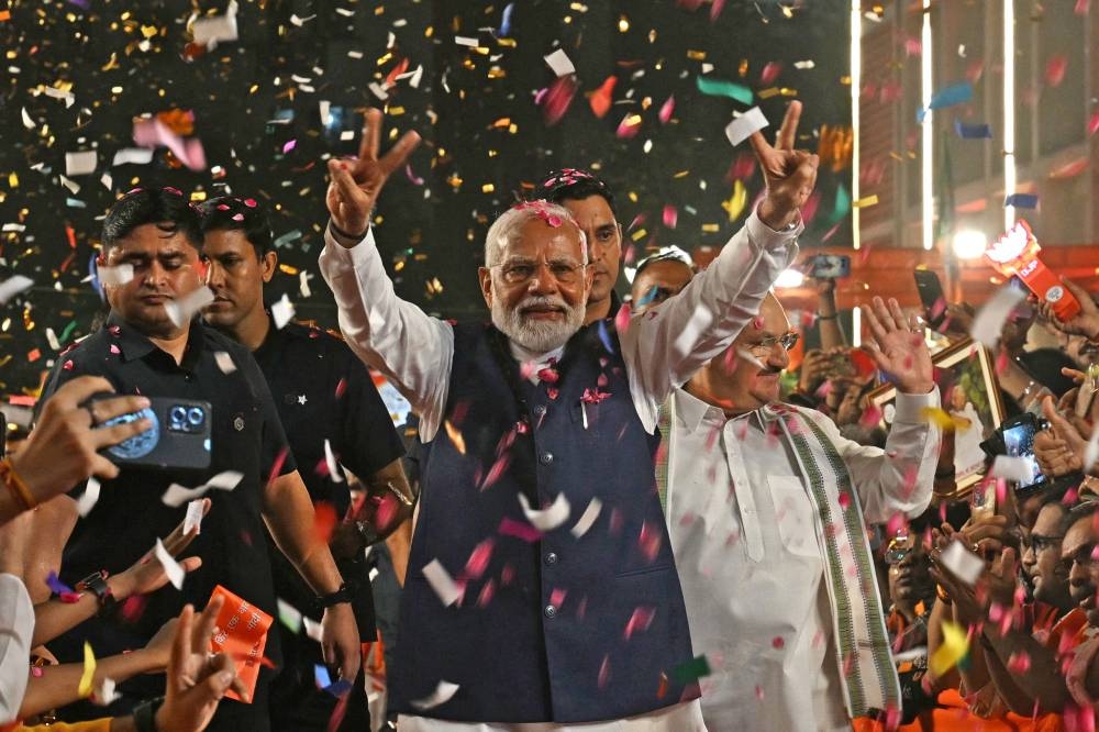 India’s Prime Minister Narendra Modi flashes victory sign as he arrives at the Bharatiya Janata Party (BJP) headquarters to celebrate the party’s win in country's general election, in New Delhi on Tuesday.