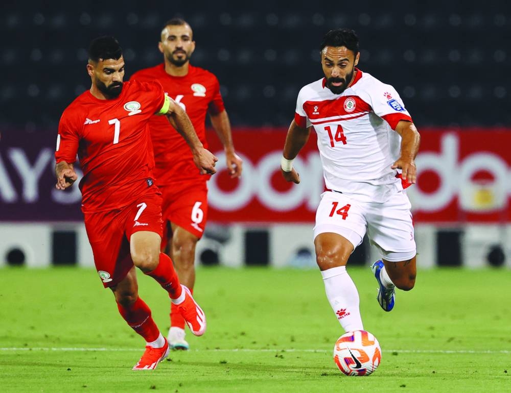 
Palestine’s Musab al-Battat (left) vies for the ball with Lebanon’s Nader Matar during the World Cup and Asian Cup qualifiers at the Jassim Bin Hamad Stadium in Doha on Thursday. (Reuters) 