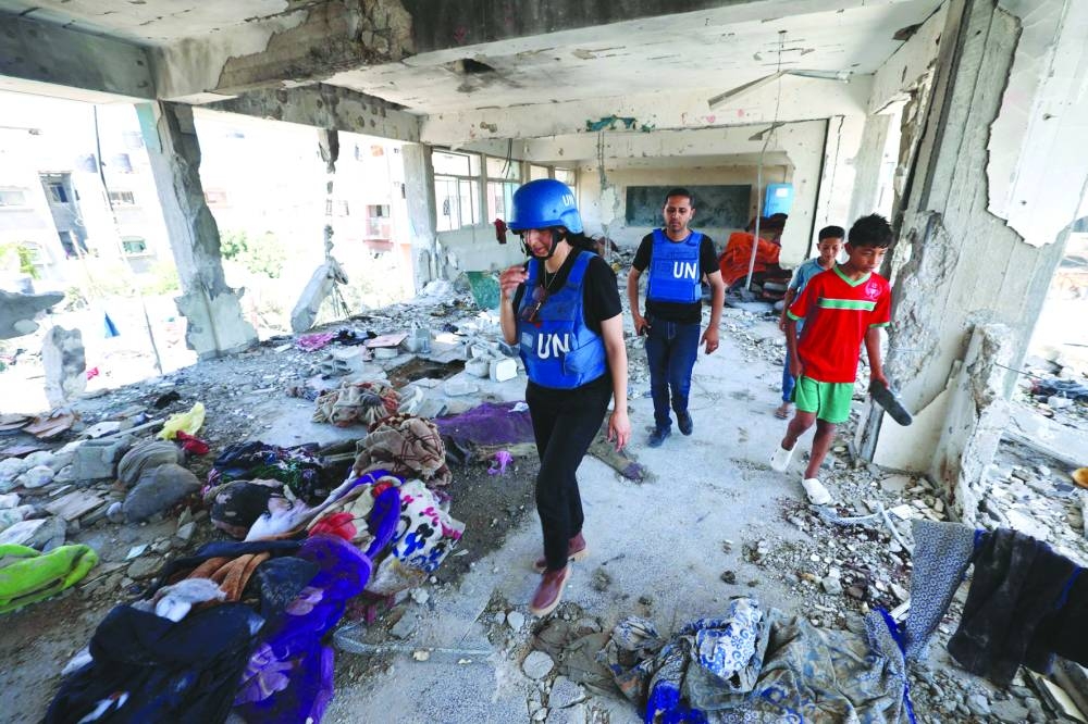 Members of a United Nations investigation team visit a school run by the UN Relief and Works Agency for Palestine Refugees (UNRWA) which was hit during an Israeli army strike the day before, in the Nuseirat camp in the central Gaza Strip, yesterday, amid the ongoing conflict in the Palestinian territory.