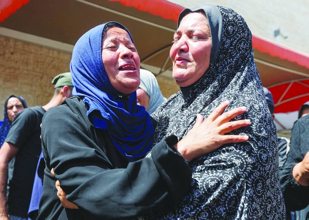 Mourners react during the funeral of Palestinians killed in Israeli strikes, amid the Israel-Hamas conflict, in Deir al-Balah, in central Gaza Strip, on Saturday.