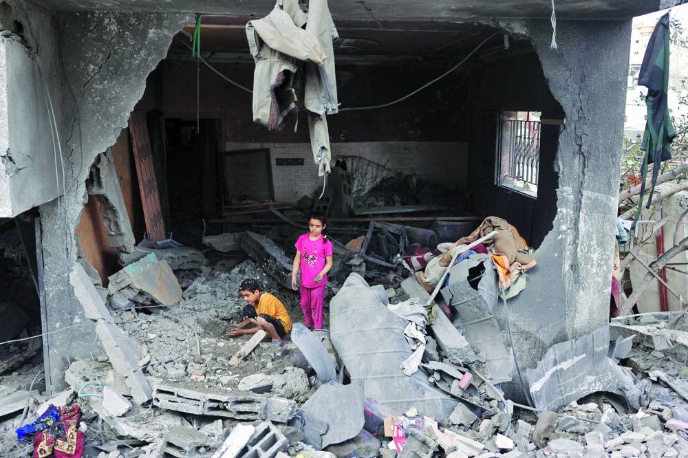 Palestinians children search through the rubble of their home a day after an operation by the Israeli Special Forces in the Nuseirat camp.
