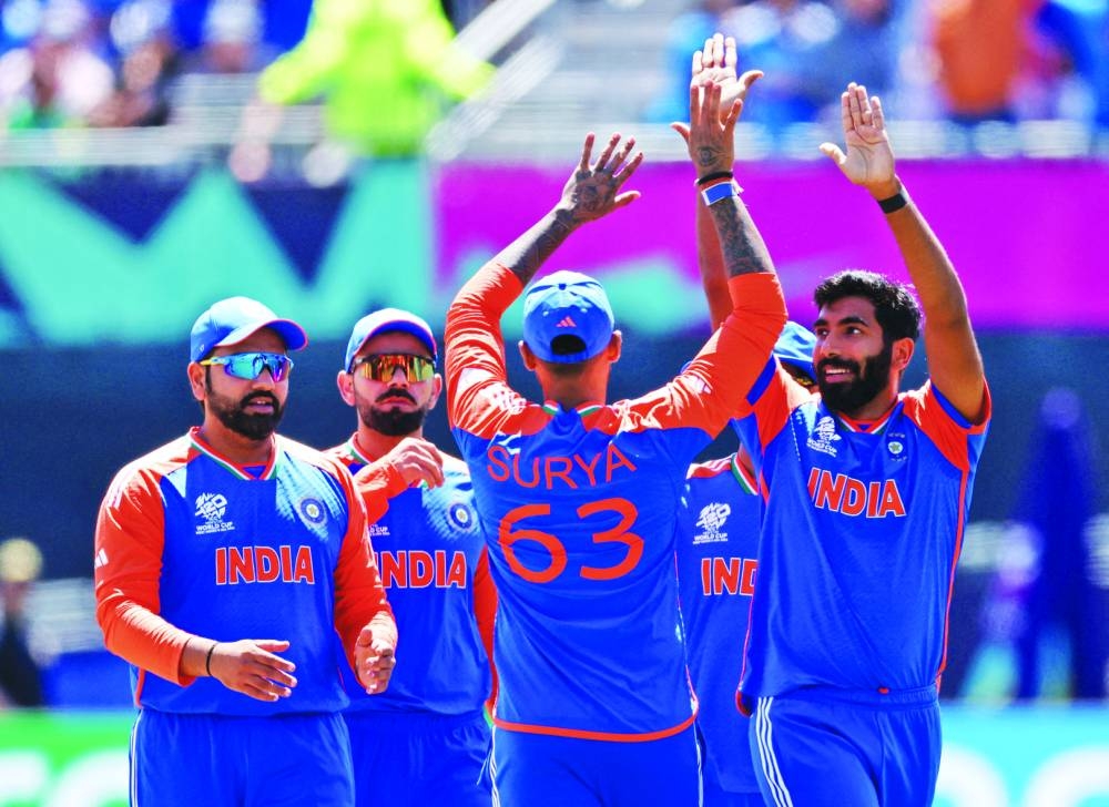 India’s Jasprit Bumrah (right) celebrates with teammates after taking the wicket of Pakistan’s Babar Azam in New York on Sunday. (Reuters)