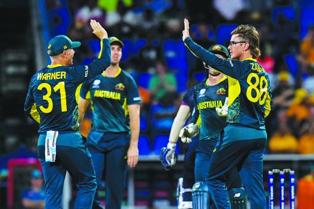 Australia’s Adam Zampa (right) celebrates the dismissal of Namibia’s Zane Green during the ICC Twenty20 World Cup match at Sir Vivian Richards Stadium in North Sound, Antigua and Barbuda on Wednesday. (AFP)