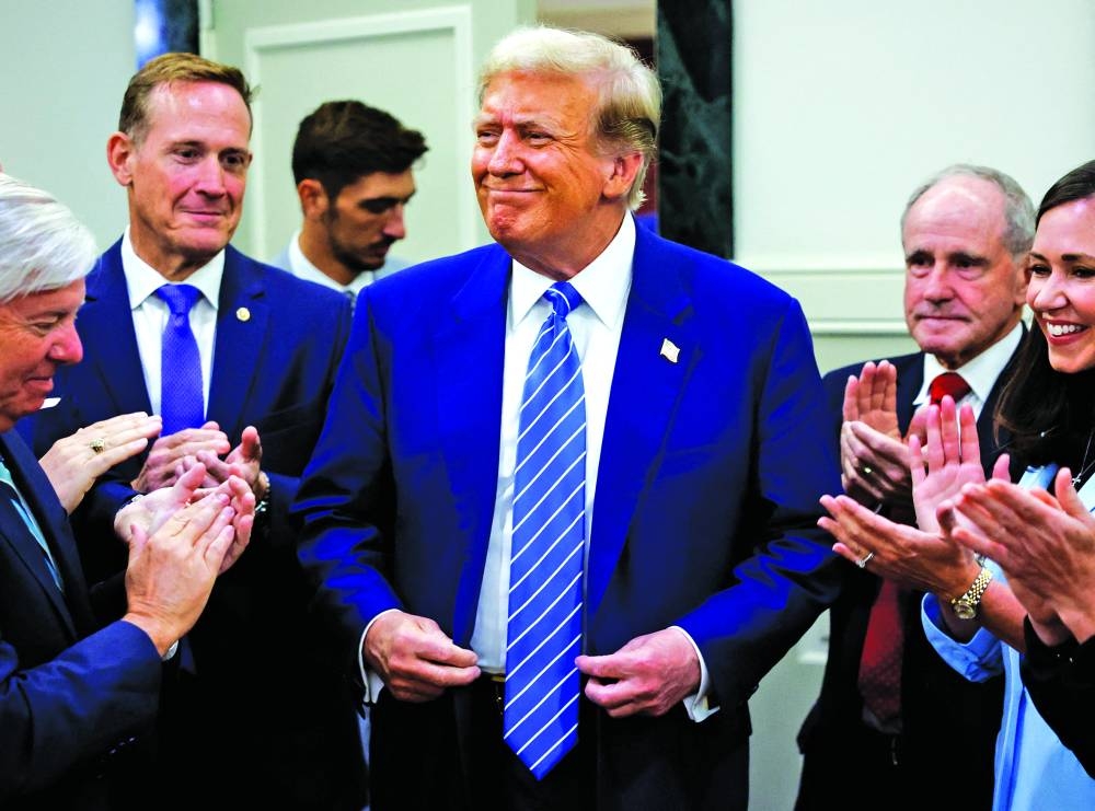 Former U.S. President and Republican presidential candidate Donald Trump reacts as he is applauded by Republicans at the National Republican Senatorial Committee (NRSC) headquarters in Washington, U.S., June 13, 2024. REUTERS/Evelyn Hockstein