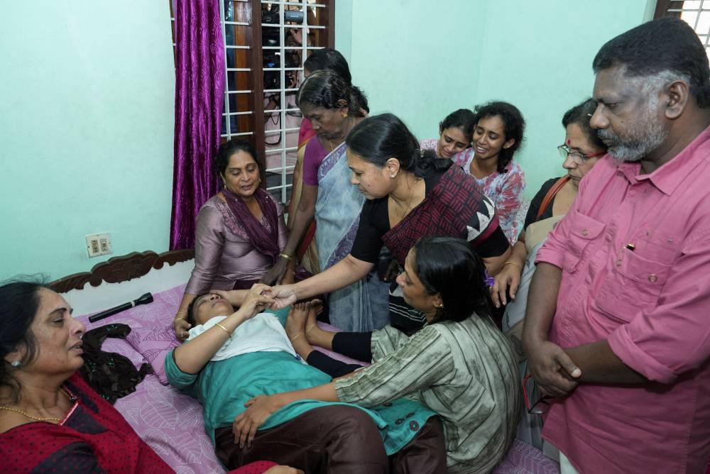 Indian politician, Veena George, who is Kerala's Minister for Health and Woman and Child Development, consoles the mother of Akash Sasidharan Nair, one of the victims of a fire that broke out in a building housing foreign workers in Kuwait, at Pathanamthitta district in the southern Indian state of Kerala, on Thursday. REUTERS