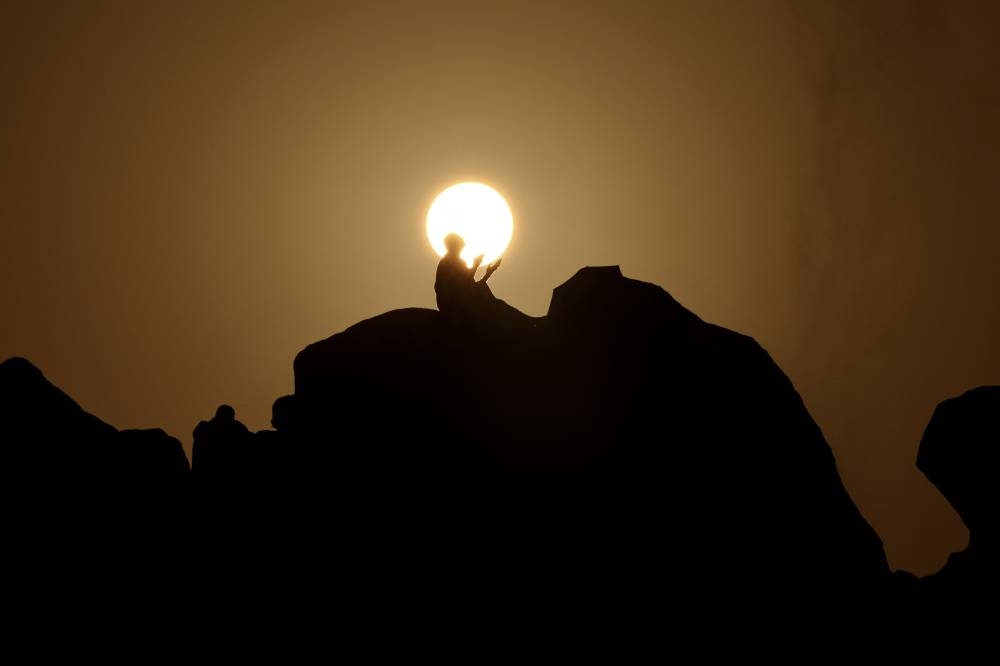 Muslim pilgrims pray at dawn on Saudi Arabia's Mount Arafat, during the climax of the Haj pilgrimage on Saturday. AFP
