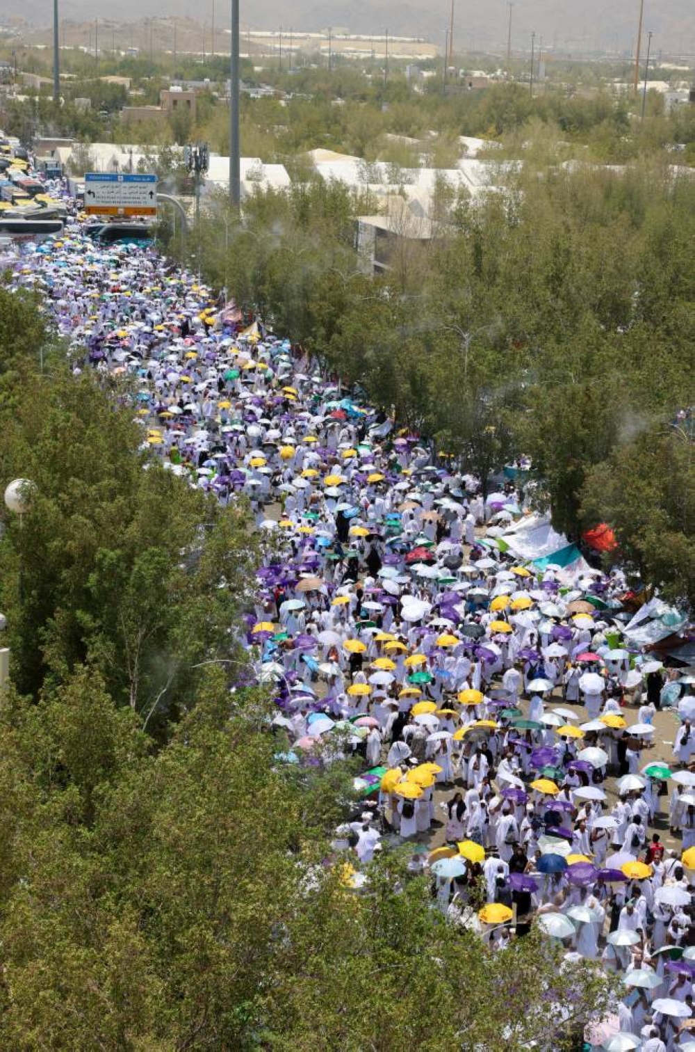 Muslim pilgrims use umbrellas to shield themselves from the sun as they gather to attend noon prayers outside Nimrah Mosque at the Plain of Arafat during the annual haj pilgrimage, outside the holy city of Mecca on Saturday. REUTERS
