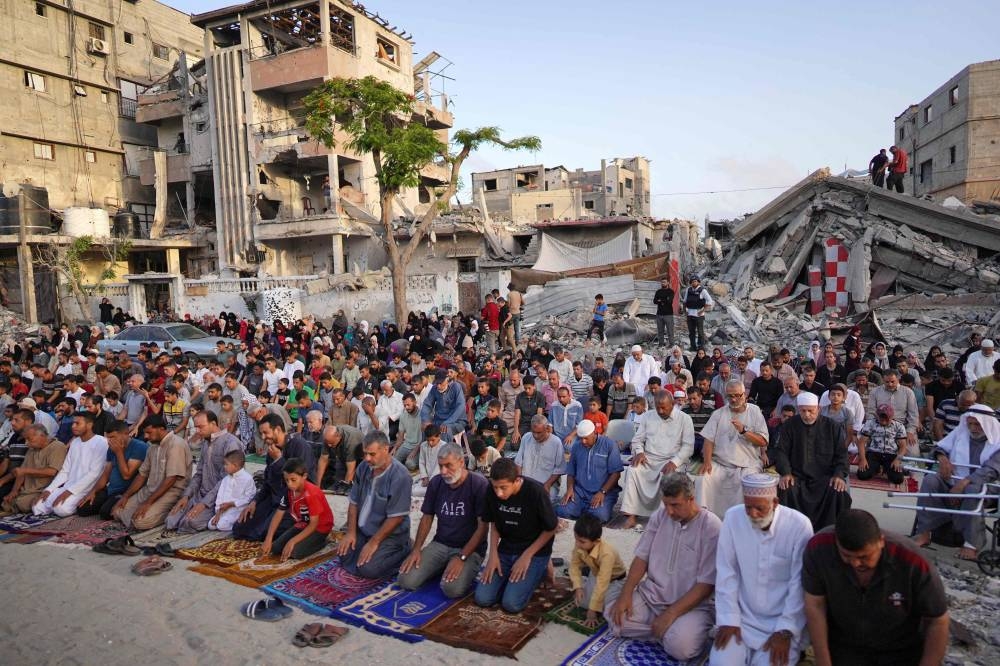 Palestinians perform the Eid al-Adha morning prayer in Khan Yunis in the southern Gaza Strip, on Sunday. AFP