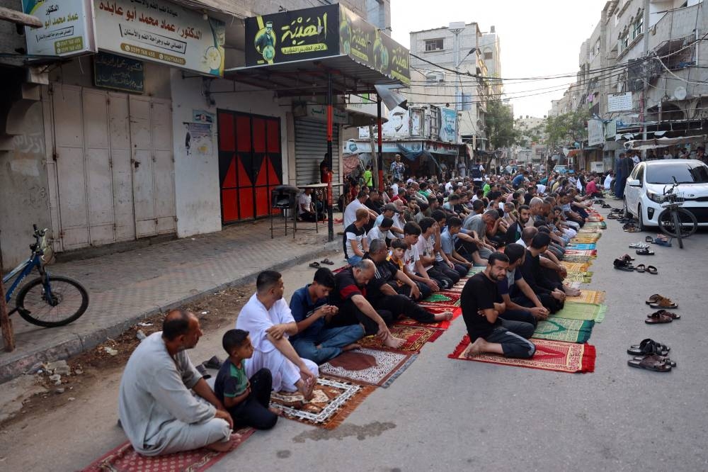 Palestinians perform the Eid al-Adha morning prayer in al-Bureij in the central Gaza Strip, on Sunday. AFP