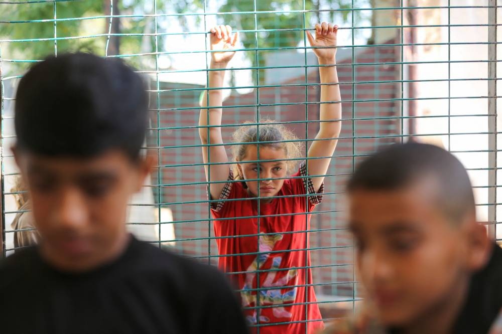 A girl looks on during the funeral of Palestinians, killed in Israeli strikes due to a military operation in Rafah on Tuesday. REUTERS