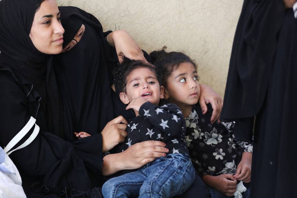Mourners react next to the bodies of Palestinians, killed in Israeli strikes due to a military operation in Rafah during their funeral in Khan Younis on Tuesday. REUTERS