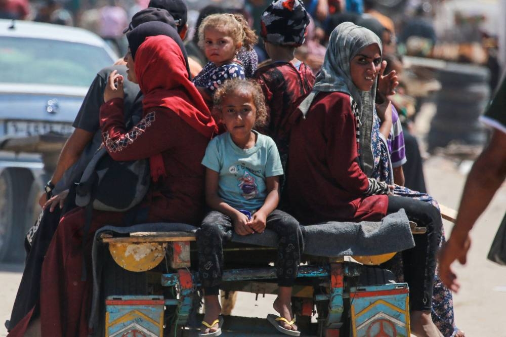 Palestinians ride in an animal-pulled cart in an area housing displaced people in Rafah, in the southern Gaza Strip, on Wednesday. AFP