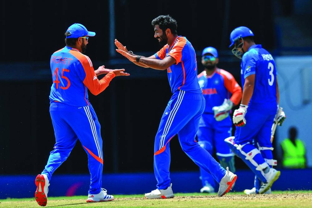 India’s Jasprit Bumrah celebrates with teammate Rohit Sharma (left) after the dismissal of Afghanistan’s Hazratullah Zazai during the ICC Twenty20 World Cup Super Eight match at Kensington Oval in Bridgetown, Barbados, on Thursday. (AFP)