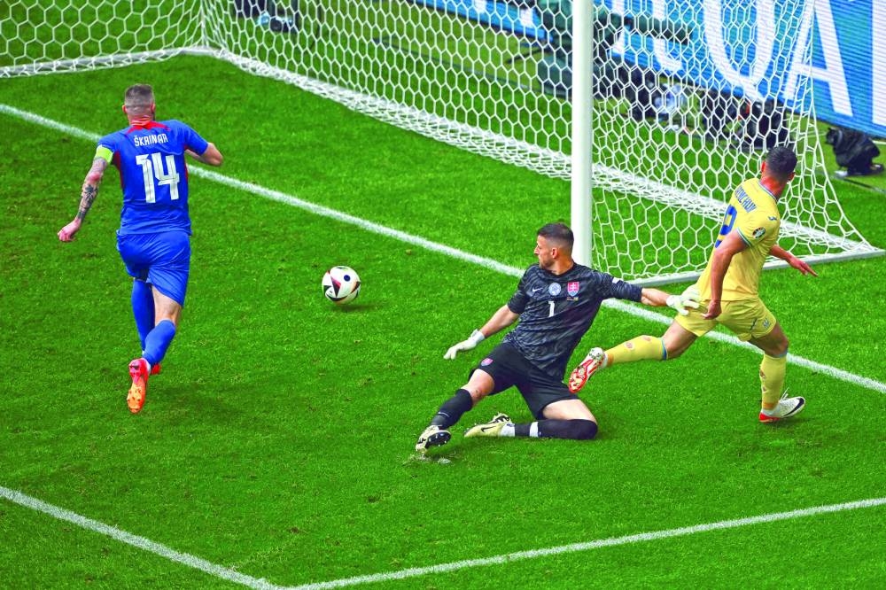 Ukraine’s forward Roman Yaremchuk (right) scores his team’s second goal past Slovakia’s goalkeeper Martin Dubravka and Slovakia’s defender Milan Skriniar during the UEFA Euro 2024 Group E match at the Duesseldorf Arena in Duesseldorf on Friday. (AFP)