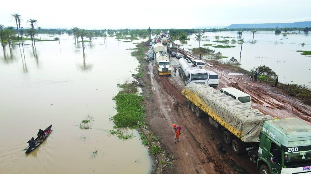 
File photo: Vehicles are seen on a road after flood water broke the bank of river Benue, in Lokoja, Nigeria, on October 13, 2022. 