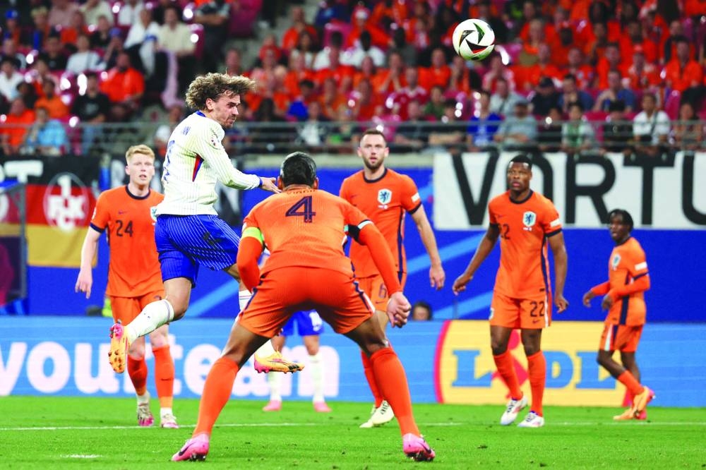 France’s midfielder Antoine Griezmann (left) heads the ball during the match against the Netherlands on Friday. (AFP)