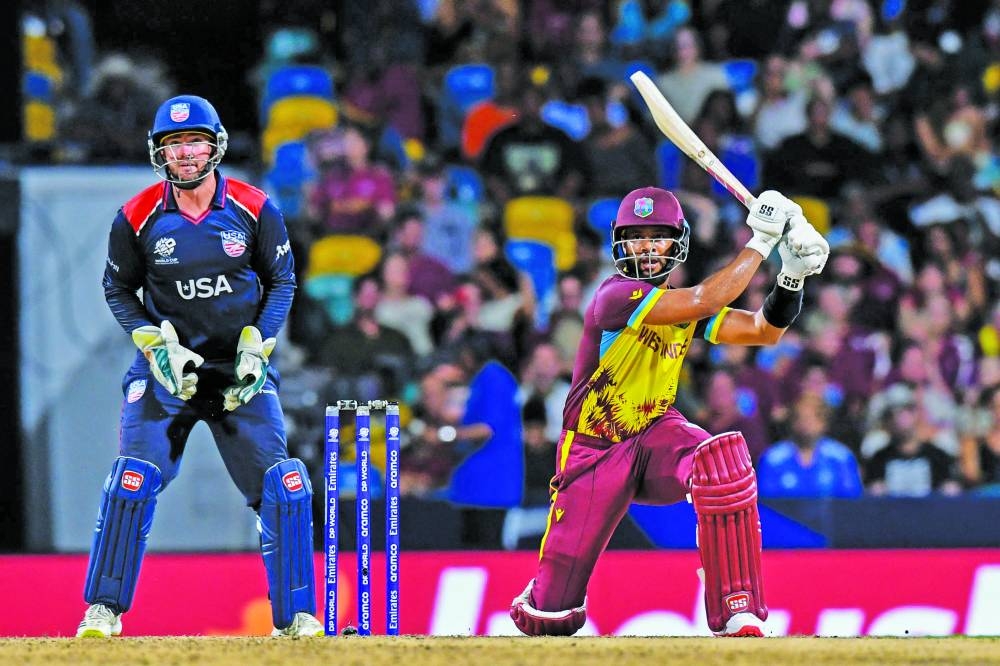 
West Indies’ Shai Hope hits a six as USA’s Andries Gous (left) looks on during the ICC men’s Twenty20 World Cup 2024 Super Eight match at Kensington Oval in Bridgetown, Barbados. (AFP) 
