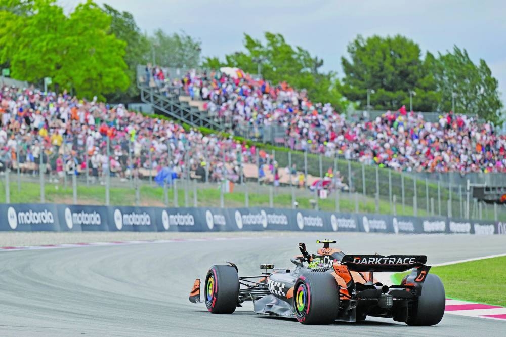McLaren’s driver Lando Norris celebrates getting the pole position after the qualification session at the Circuit de Catalunya in Montmelo, on the outskirts of Barcelona, during the Spanish One Grand Prix on Saturday. (AFP)