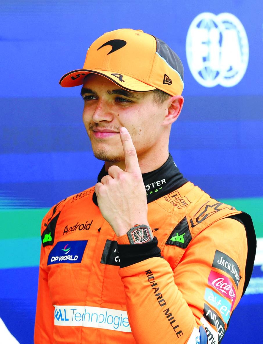 McLaren's Lando Norris celebrates after qualifying in pole position (Reuters)