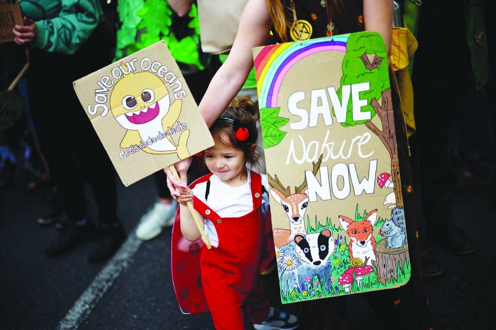 
A girl holds placards as she joins the protest. 