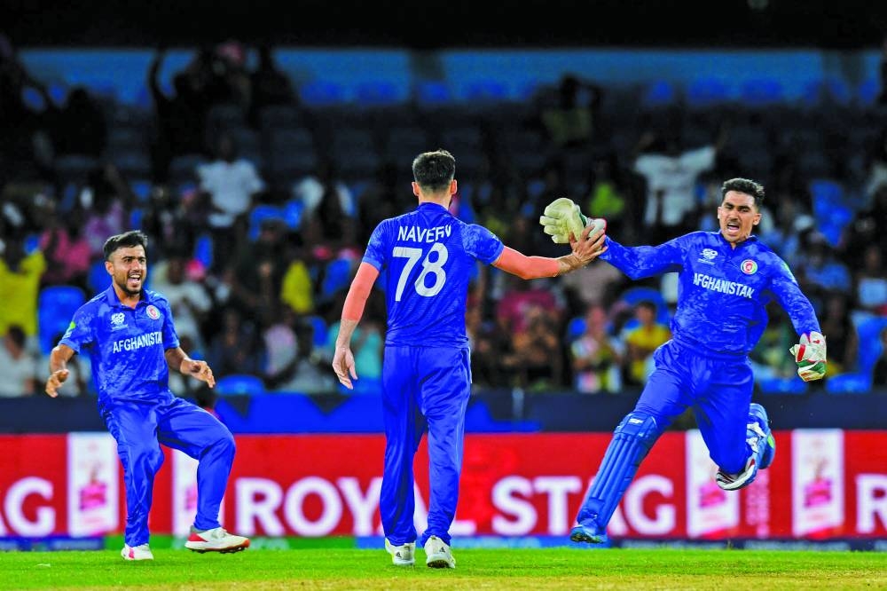Afghanistan's Nangyal Kharoti (left), Naveen-ul-Haq (centre) and Gulbadin Naib (right) celebrates after the dismissal of Australia's Ashton Agar during the ICC Twenty20 World Cup Super Eight match at Arnos Vale Stadium in Arnos Vale, Saint Vincent and the Grenadines yesterday. (AFP)