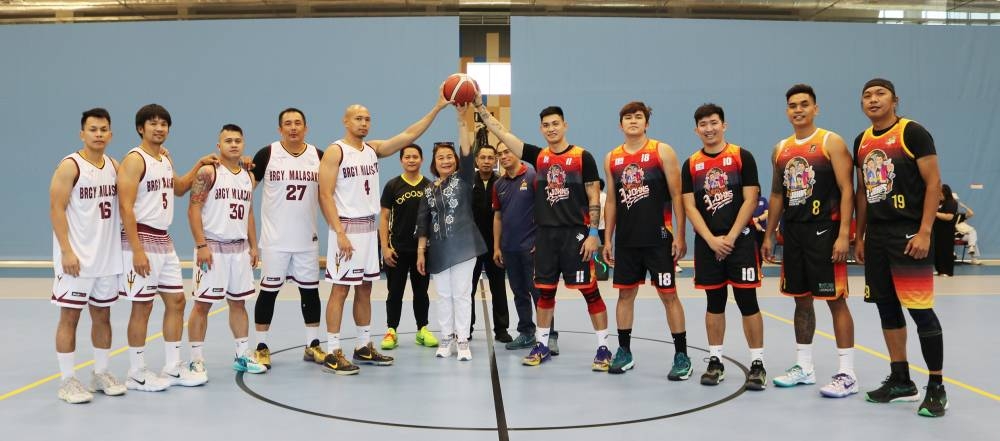 Philippine ambassador Lillibeth V Pono leads the ceremonial toss to mark the start of the competition.
