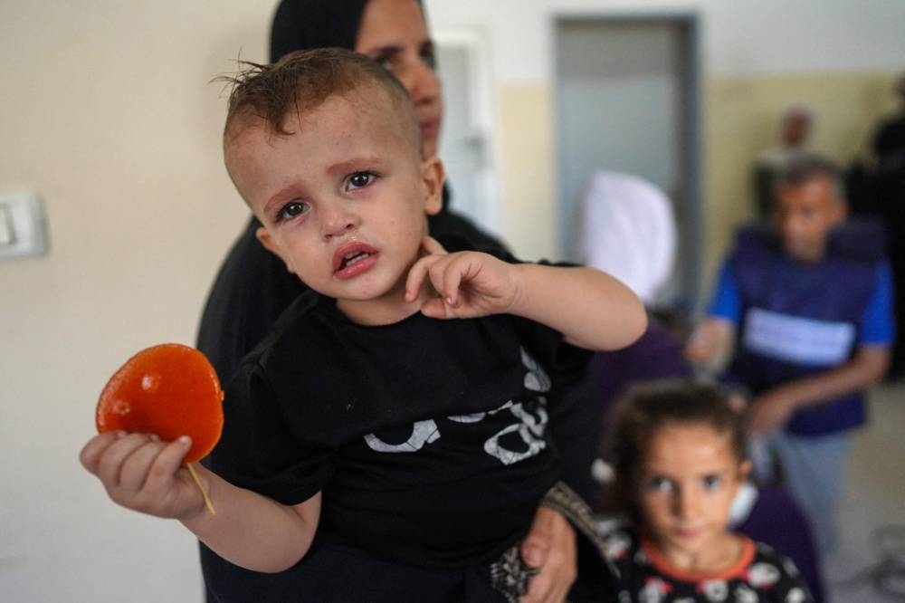 Palestinian children suffering of malnutrition or chronic diseases such as cancer, wait with family members at Nasser hospital in Khan Yunis in the southern Gaza Strip on Monday. AFP