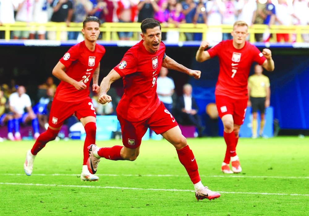 Poland’s Robert Lewandowski celebrates scoring a goal against France during their Euro 2024 Group D match in Dortmund on Tuesday. (Reuters)