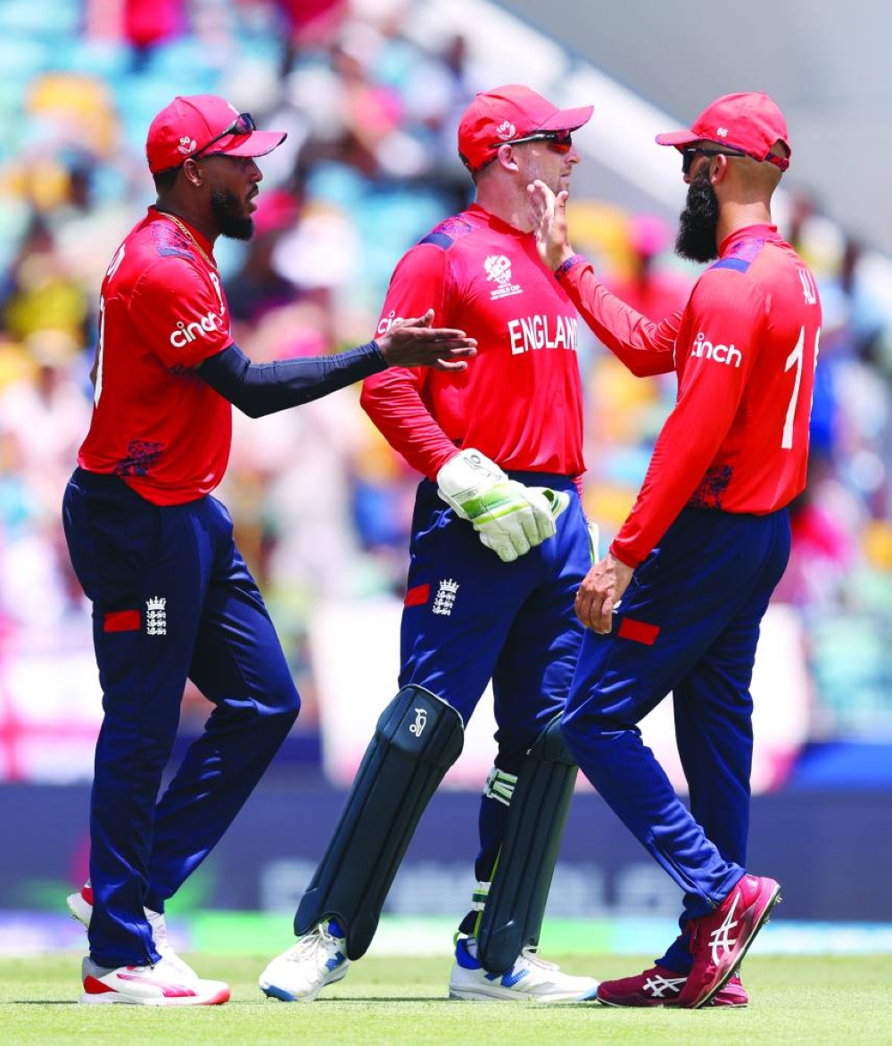 
England captain Jos Buttler (centre) is seen with teammates Chris Jordan (left) and Moeen Ali during their ICC T20 World Cup match against USA on Sunday. (@englandcricket) 