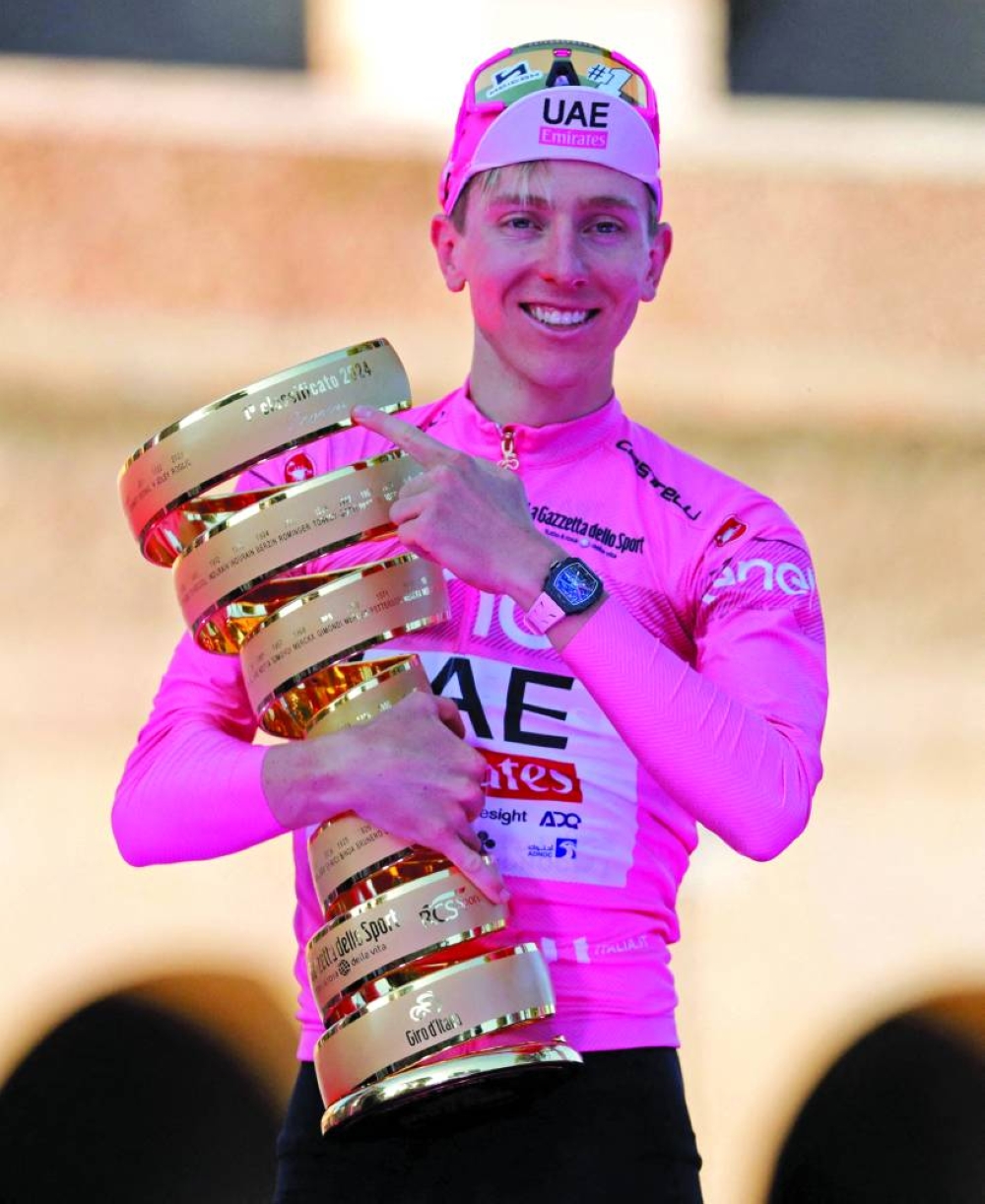 
UAE Team Emirates’ Tadej Pogacar celebrates on the podium with the trophy after winning the Giro d’Italia 2024 on May 26, 2024. (Reuters) 