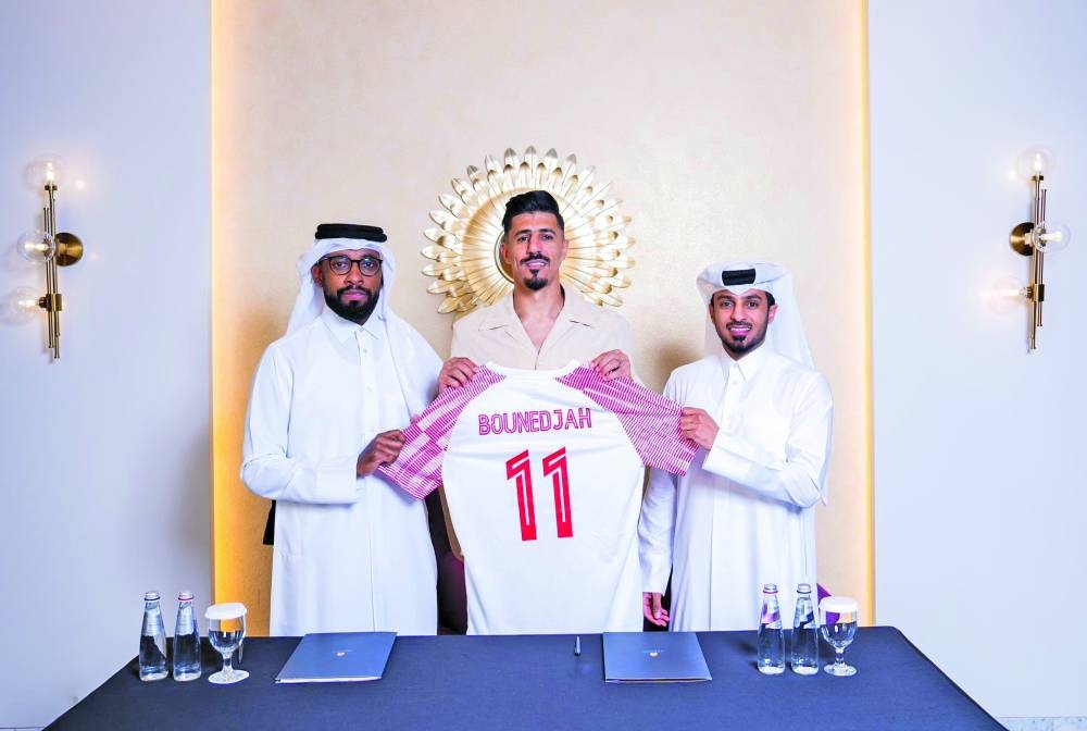 
Algerian striker Baghdad Bounedjah is seen with head of the Al Shamal club’s football team Mashal al-Ali and manager Ahmed Hussain al-Sada after signing a two-year deal with the Qatar Stars League side. Bounedjah has left Al Sadd after a nine-year stint. 