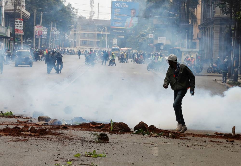 A protester reacts to tear gas during a demonstration over police killings of people protesting against Kenya's proposed finance bill 2024/2025, in Nairobi, Kenya, June 27, 2024. REUTERS/Monicah Mwangi