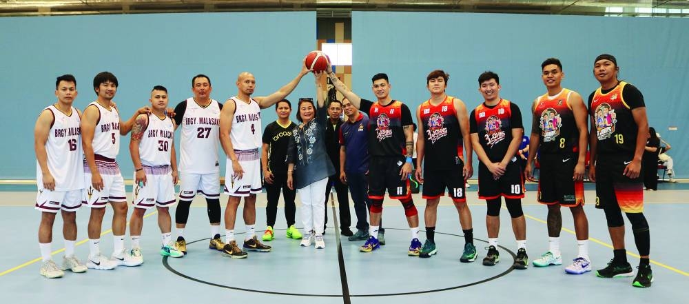 Philippine ambassador Lillibeth V Pono leads the ceremonial toss to mark the start of the competition.